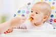 Mom feeds funny baby from  spoon