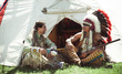 Photo: North American Indians sit at a wigwam North American Indians sit at a wigwam