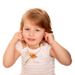 Little girl closing ears with fingers.
