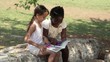 Children and education, female friends reading book in park