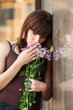 Photo: Sad young woman with a flowers Sad young woman with a flowers