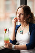 Photo: Sad woman with coctail looking out the window Sad woman with coctail looking out the window