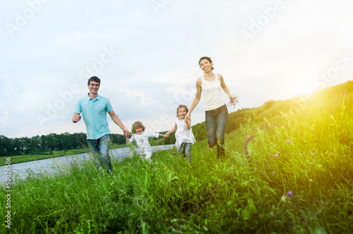 Photo: happy family having fun outdoors happy family having fun outdoors