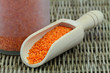 Dry red lentils in wooden scoop