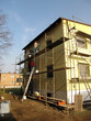 Application of colored plaster on the facade of the building