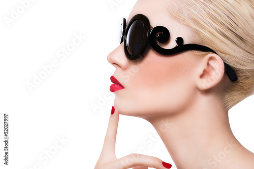 Photo: Beautiful blonde girl in sunglasses with red lips on white backg Beautiful blonde girl in sunglasses with red lips on white backg
