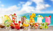 Summer cocktails with pieces of fruit on wooden table