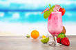 Summer cocktail with pieces of fruit on wooden table