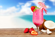Summer cocktail with pieces of fruit on wooden table
