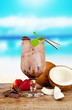 Summer cocktail with pieces of fruit on wooden table