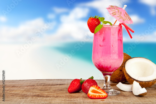 Photo: Summer cocktail with pieces of fruit on wooden table Summer cocktail with pieces of fruit on wooden table
