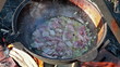 Cooking pilaf. The meat is stewed with onions