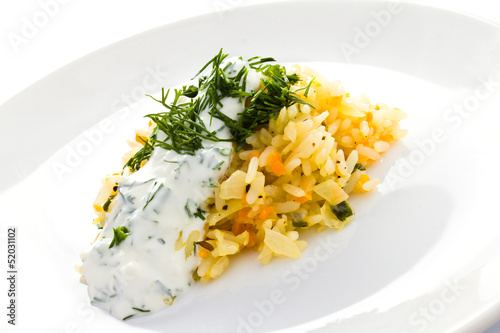 Photo: White rice with garlic sauce on a plate on white background White rice with garlic sauce on a plate on white background