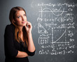 Photo: Beautiful school girl thinking about complex mathematical signs Beautiful school girl thinking about complex mathematical signs
