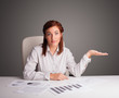 Photo: Businesswoman sitting at desk and doing paperwork Businesswoman sitting at desk and doing paperwork
