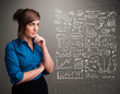 Pretty woman looking at stock market graphs and symbols