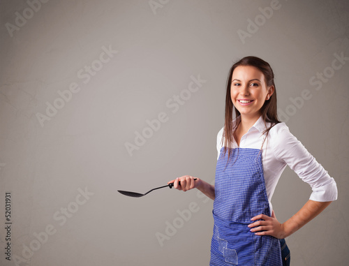 Photo: Pretty woman holding a spoon Pretty woman holding a spoon