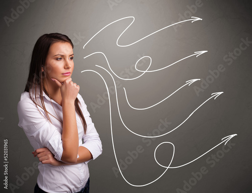 Photo: Attractive teenager looking at multiple curly arrows Attractive teenager looking at multiple curly arrows