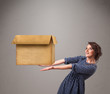 Photo: Young woman holding an empty cardboard box Young woman holding an empty cardboard box