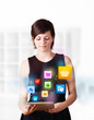 Photo: Young woman looking at modern tablet with colourful icons Young woman looking at modern tablet with colourful icons