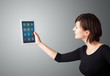 woman holding modern tablet with colorful icons