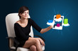 Photo: woman holding modern tablet with colorful shopping bags on cloud woman holding modern tablet with colorful shopping bags on cloud