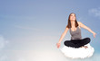 Young woman sitting on cloud with copy space