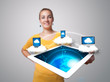Photo: Young woman holding tablet with modern devices Young woman holding tablet with modern devices