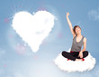 Photo: Beautiful lovely woman sitting on cloud with heart Beautiful lovely woman sitting on cloud with heart