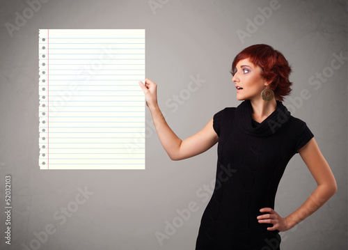 Photo: Young woman holding white paper copy space with diagonal lines Young woman holding white paper copy space with diagonal lines