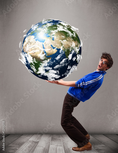 Photo: Good-looking man holding 3d planet earth Good-looking man holding 3d planet earth