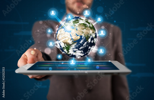 Photo: Businessman presenting 3d earth globe in tablet Businessman presenting 3d earth globe in tablet