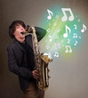 Young musician playing on saxophone while musical notes explodin