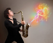 Attractive musician playing on saxophone with colorful abstract