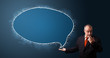 Photo: funny businessman holding a phone and presenting speech bubble c funny businessman holding a phone and presenting speech bubble c