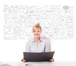 Foto: Pretty businesswoman planning and calculating various business i Pretty businesswoman planning and calculating various business i