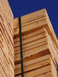 Stacks of planks against the deep blue sky