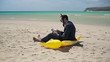 Businessman in diving mask working on tablet computer on beach