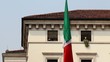 Italian flag waving in front of a bright house