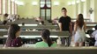 Group of happy students and friends in school library
