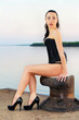 Brunette posing on the pier