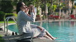 Successful businesswomen drinking beer by the swimming pool