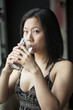 Beautiful Young Woman with Brown Hair and Eyes Drinking Water