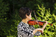 Senior woman playing music outdoors