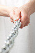 hands holding a chain. isolated on white background