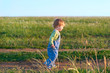 jolly child in the jeans  coverall off down the road