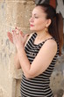 Brunette woman near the door, holding hands