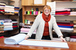  salesclerk measures the fabric