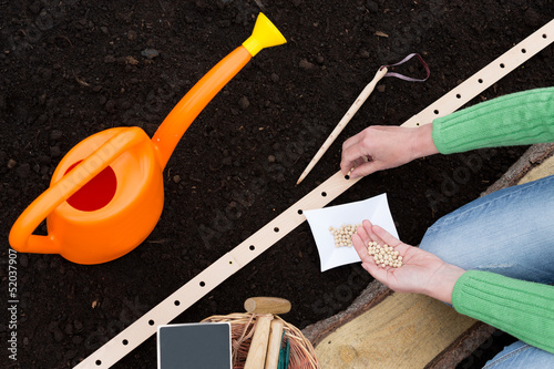 Photo: Gardening - woman sowing seeds into the soil Gardening - woman sowing seeds into the soil
