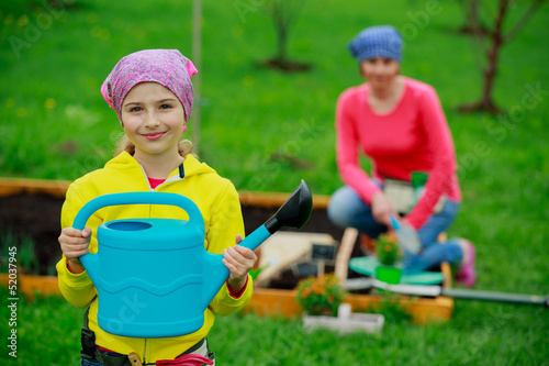 Photo: Gardening - young girl helping in the garden Gardening - young girl helping in the garden